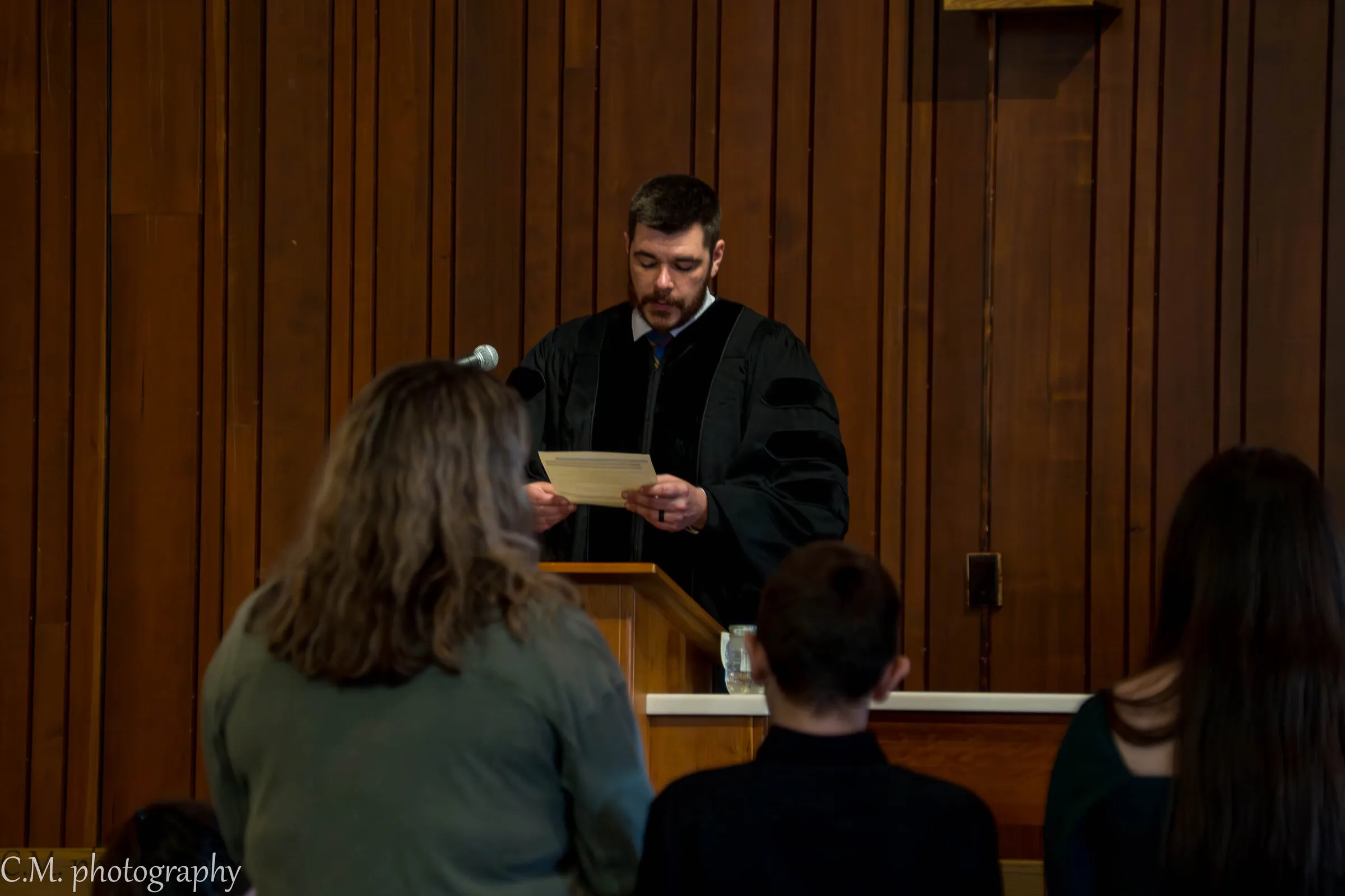 The pastor reading Scripture to the congregation