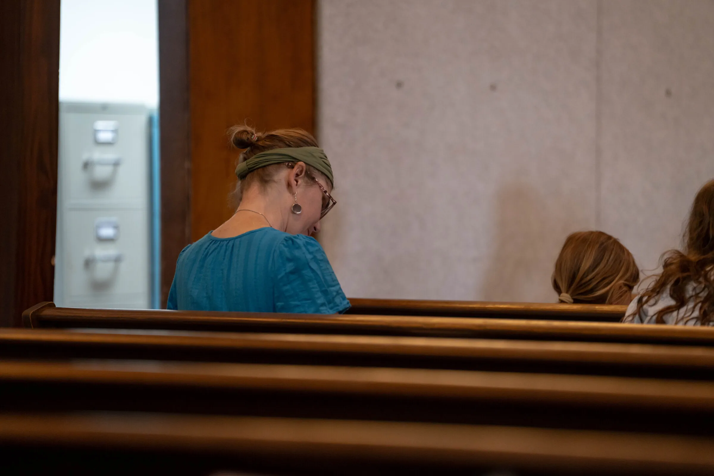 A woman in prayer during the service