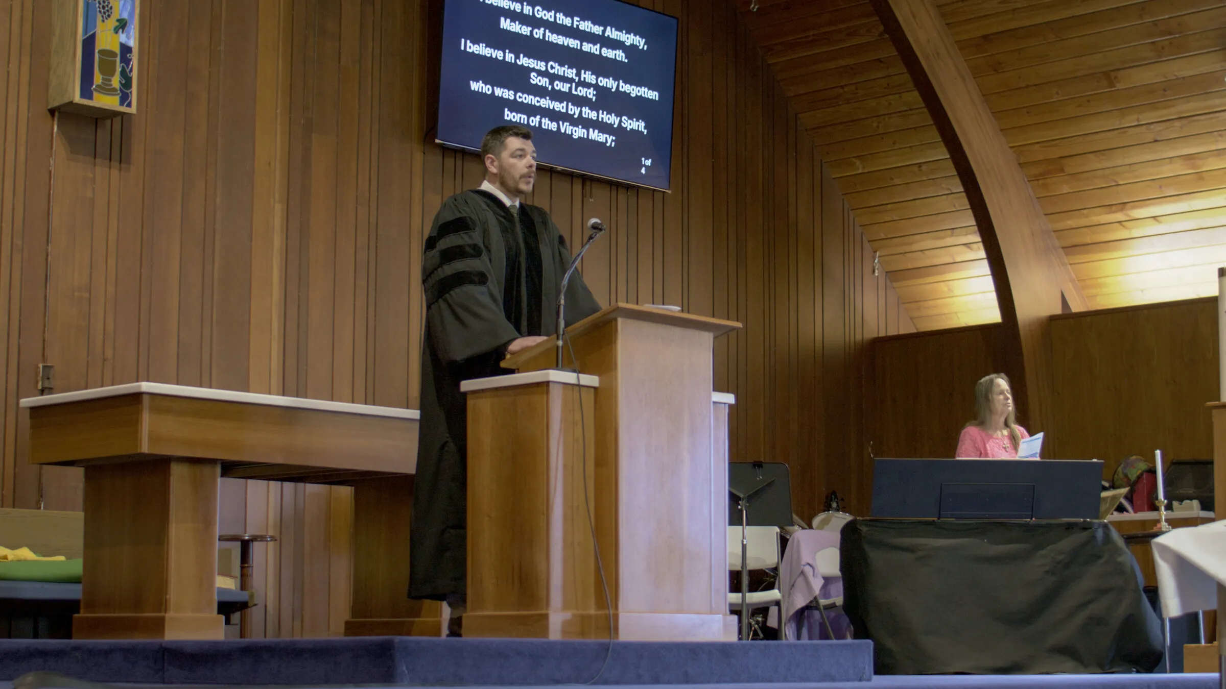The pastor at the pulpit beside the communion table